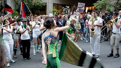 The Rude Mechanical Orchestra takes up their instruments while Becca flies her flag.