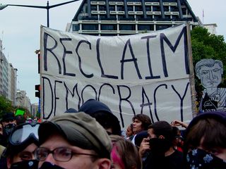 Perhaps the largest and most noticeable banner was this large, white one, reading "Reclaim Democracy".