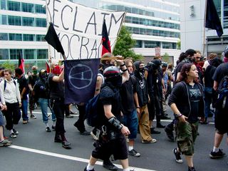 The black bloc, now by itself, attempts to continue on.