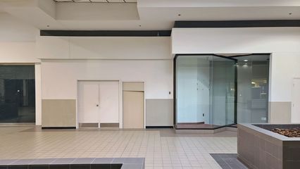 These two store spaces have been walled off for as long as I can remember.  It is possible that these spaces were never leased throughout the mall's entire history, according to a longtime mall tenant that I corresponded with online.