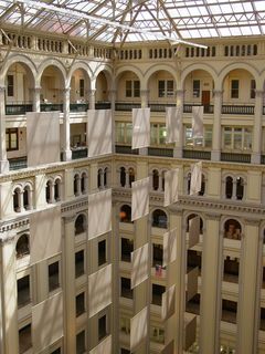 The Old Post Office's atrium is amazing. It's the centerpiece of the building, and the view from above is breathtaking. Everything looks so small down below. The glass elevator is visible in the upper right photo.