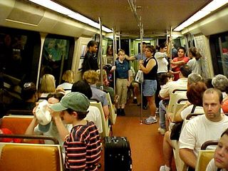 On the old Breda trains, the carpet is orange, the walls are cream-colored, the handles on top of the seats are brown rubber, and the seats themselves are two different shades of orange. On the new Series 5000 trains, the carpet is a burgundy color, the walls are white, the handles on top of the seats are brushed metal, and the seats themselves are burgundy and blue-gray.