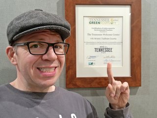 Selfie with the Tennessee certificate, pointing at the name of the state.  In other words, proof that we had cleared Virginia, and had entered Tennessee.