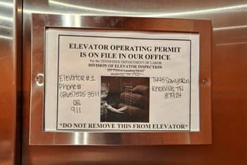 Sign in the spot for the operating certificate in one of the elevators.  Not the classiest looking, for sure, considering the handwritten notes, and the "DO NOT REMOVE THIS FROM ELEVATOR" admonishment.
