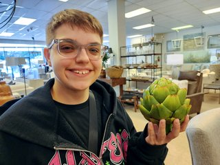 Elyse poses for a photo with a plastic artichoke at O.P. Jenkins.