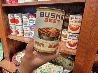 Elyse holds up a can with a vintage label.  These cans were intended for decoration, and as such were empty.  The gift shop did also sell full cans of Bush's beans in the gift shop, but those cans were sold with the standard retail labeling that you would see anywhere.