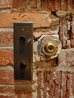 Vintage freight elevator buttons along with a third button in a building in downtown Kingsport.