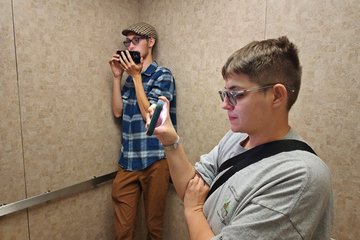 Elyse and Jackson film the parking garage elevator in downtown Kingsport.