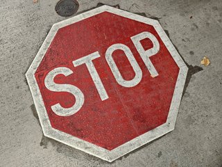 Stop sign embedded in the floor of the parking garage.