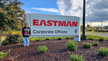 Elyse poses with the Eastman sign.