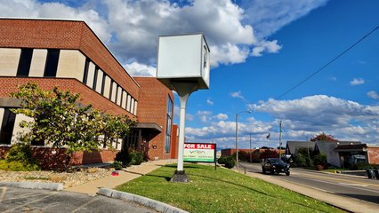 What looked like a former Kroger cube sign, now containing a clock.