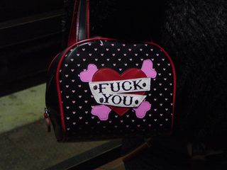 On the elevator at Fort Totten station, I was quite surprised to see this teenaged girl's handbag. It certainly sends a strong message...