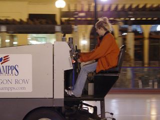 Rheannin, one of the employees at the Pentagon Row ice rink, resurfaces the ice by taking the Zamboni out for a spin.