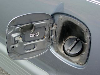 The Previa's fuel door was something I had to rig up. I don't remember how it originally was set up, but it stopped popping open when I hit the switch. If you look carefully near the bottom of the hinge in the center of the photo, I stuck a little piece of metal in there to act like a spring. Worked like a charm.