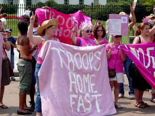 On July 4, Code Pink held a large demonstration in the street in front of the White House. Here, they gave Bush a giant "pink slip", which you can partly see in the bottom photo.