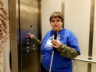 Elyse presses the button for the sixth floor on the elevator.  While the elevators were still original when I visited in 1999, they have since been upgraded a few times.