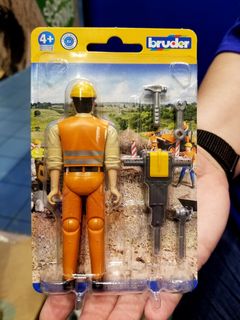 We found a toy set with a manufacturing error, seen at left.  Clearly, this construction worker wasn't supposed to be facing away in the package, but there he was.  Rather, he was supposed to be facing outward, like the otherwise identical set to the right.