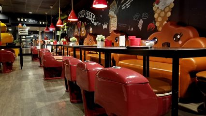 Poop Cafe.  Note that the seats are real toilets, and the benches in back are shaped to resemble poop.