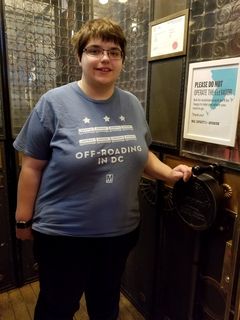 Elyse poses for a photo with the manual elevator handle.