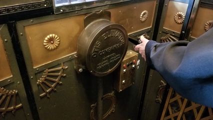 An employee at the Gladstone operates the elevator.