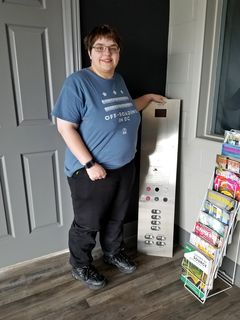 Elyse poses with the elevator panel.