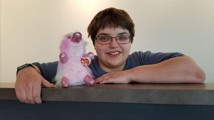 Elyse poses with a Beanie Baby toy at the duty free shop.