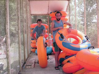 Staff members unload tubes from the trailer for our use.