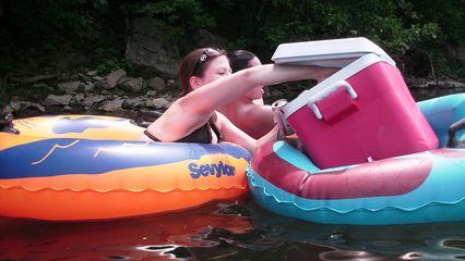 Christina reaches into one of the coolers in order to fish out her lunch.