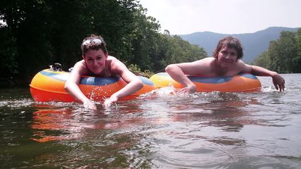 Becca and Jordan paddle along in the water.