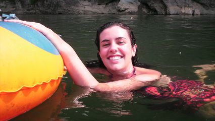 Cristina floats alongside her tube.