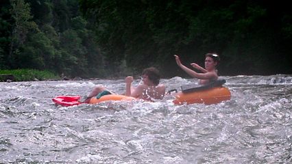 Becca and Jordan ride through the rapids.