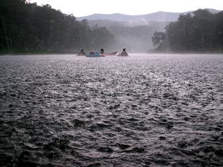 The rain is still falling hard, but the sky is lighter - will the rain end soon?