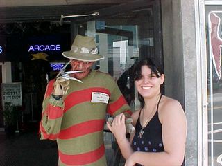 Renee poses with Freddy Krueger in front of a store.