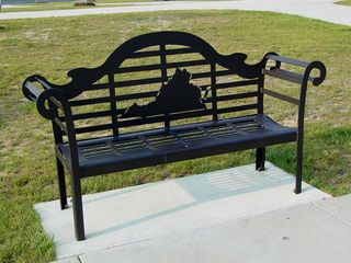 Outside the rest area building, the usual facilities can be found, though with a more updated look to them. Note how the picnic table is not in line with the sidewalk and the canopy - it's at an angle! Also notice the bench - much more ornate, and sporting an outline of Virginia, which actually ended up being a recurring theme here.