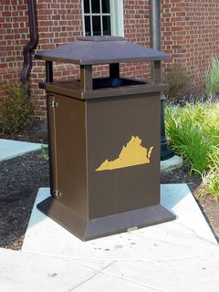 Waste receptacles, both for trash and for recycling, share the outline-of-the-state theme that is found all over this rest area.