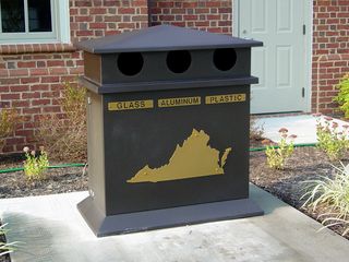 Waste receptacles, both for trash and for recycling, share the outline-of-the-state theme that is found all over this rest area.