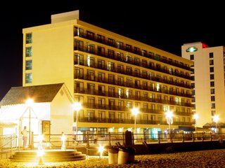 The Ocean Holiday stands here, lit up by the light of the boardwalk. My room is the fourth one from the left on the top floor. My light is on, but the curtains are closed.