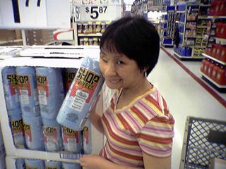 Near the Automotive department, Becky poses with a roll of Scott Shop Towels.