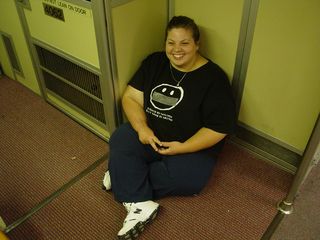 Katie sits on the floor in a corner of Breda 4062 near the cab.