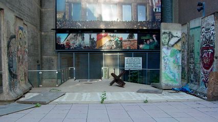 The guard tower was gone, and the pieces of the Berlin Wall were moved out of the way, presumably to facilitate the tower's removal.