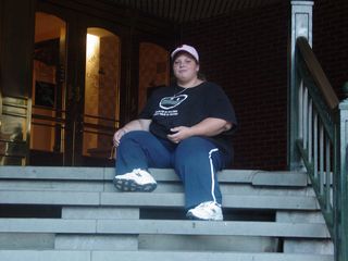 Katie sits on the steps at the back entrance to The Shops at Georgetown Park.