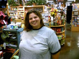 Katie strikes a pose next to a rack of Crocs.