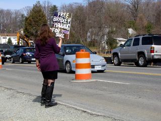 Some demonstrators walked along the roadside, holding up their signs for the traffic on Route 1 to see.