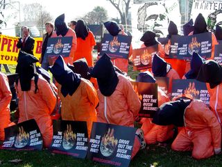 At a World Can't Wait rally on January 4, a number of people dressed in orange jumpsuits and black hoods, intended to symbolize Guantanamo Bay detainees and torture victims.