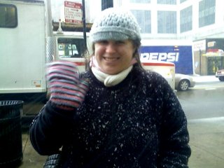 The next day, Mom, Sis, and I went and wandered around the Magnificent Mile. As Sis demonstrates by what has collected on her coat, it was snowing...