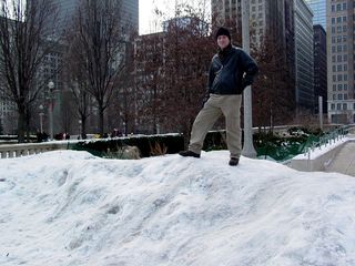 Nearby, Chris is the king of the snow pile, having climbed up to the top. No way on earth will you ever find me up there...