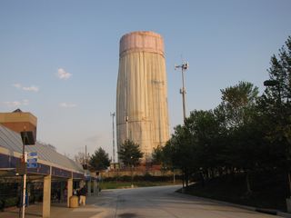 During 2009, the water tower next to Glenmont station was being repainted. At times, the water tower was covered only at the top, and other times, seen here, it was fully covered. It was quite strange to see the water tower covered like this, though. It kind of looks like something sinister in a movie, but in this case, it's just painting...