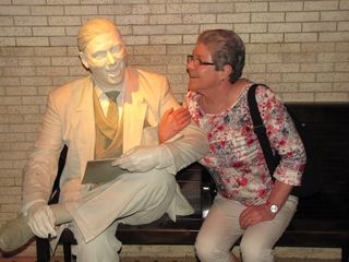 One of Mom's favorite things to do with statues of people that you can get all around is to pretend like she's interacting with them. This works best at wax museums where the figures are colored realistically, but it still worked here, and Mom and I had a blast posing these shots.