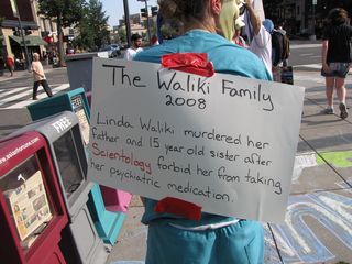 More displaying of the victims-of-Scientology signs. One person taped it to her back, while I posed with a sign.