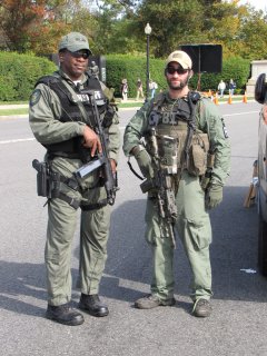 On October 25, while waiting to meet up with Isis and Cubby to photograph in Arlington Cemetery, I got to observe some of the 2009 Marine Corps Marathon in progress. These two law enforcement officers, representing Arlington County (left) and the FBI (right), were a bit over the top. Are the big guns really necessary for this sort of event? Really?